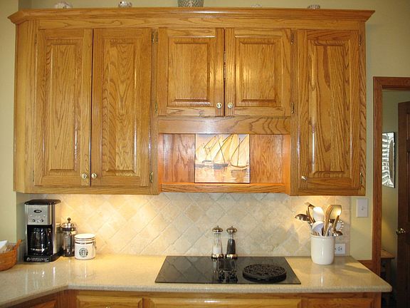 Detail of the backsplash and counters, lovely wood cabinetry.