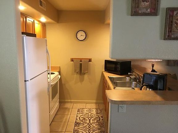 Kitchen as viewed from dining area.
Full size range with oven, refrigerator and dishwasher.