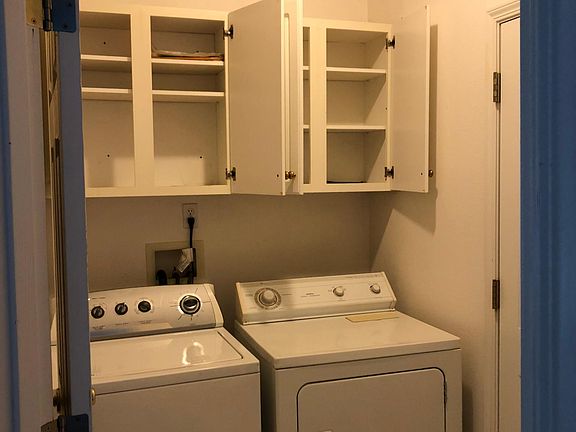 Laundry Room - Washer/Dryer plus cabinet space. Doors to Garage and Family Room.