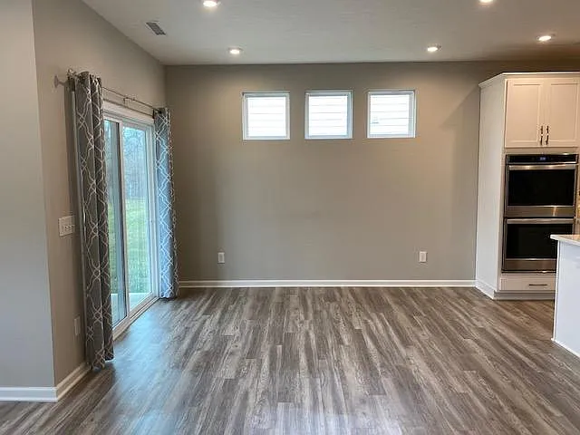 Dining area and sliding glass door to patio and backyard for pet