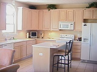 Kitchen has 42' maple cabinets, large pantry and island with seating.