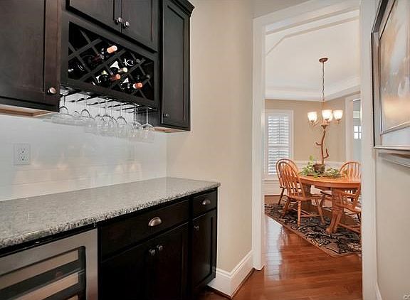 Butlers Pantry with cabinets, wine rack, granite, and wine cooler!