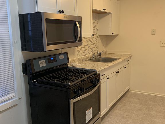 New range and built in microwave -- with brand new white cabinets-