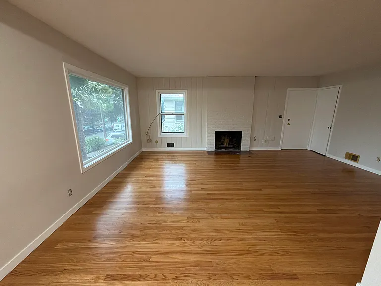 Living room with main entrance to right of fireplace.