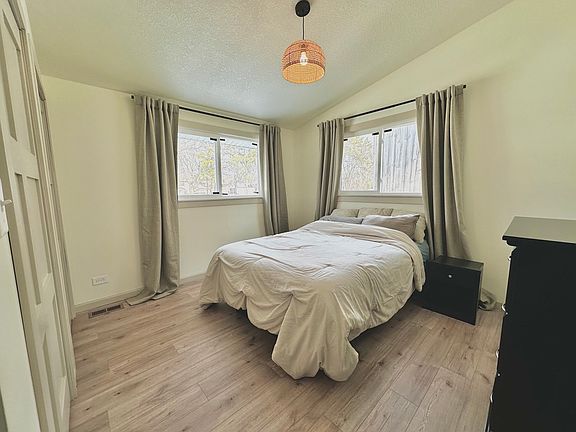 Main floor bedroom (1st of 2) with a wide double closet.

(Bed pictured is queen size)