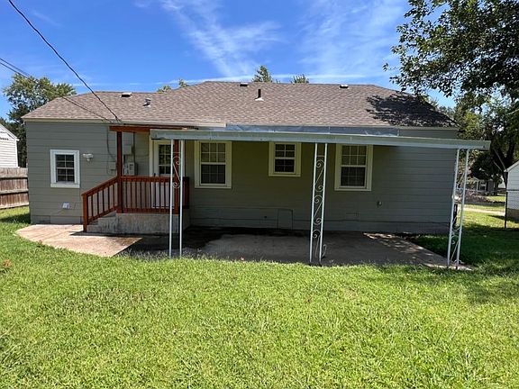 Rear Elevation as viewed from back yard showing newly covered rear entry and large covered patio ready for entertaining family and guests.