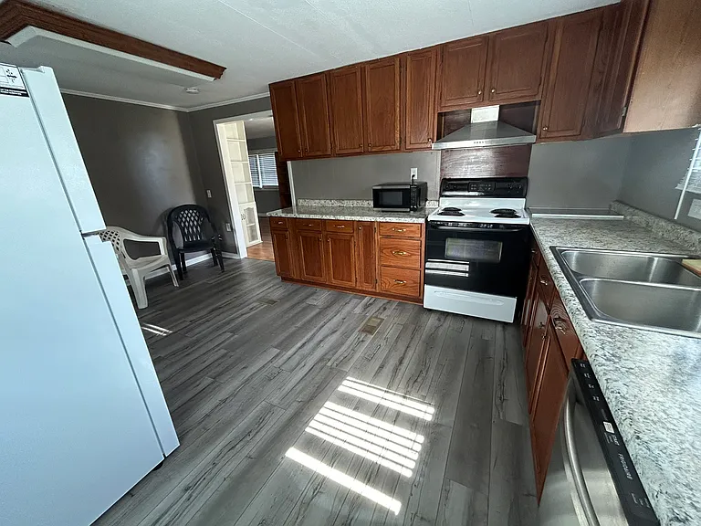 View of the Kitchen in natural light. The door leads to the Dining Room