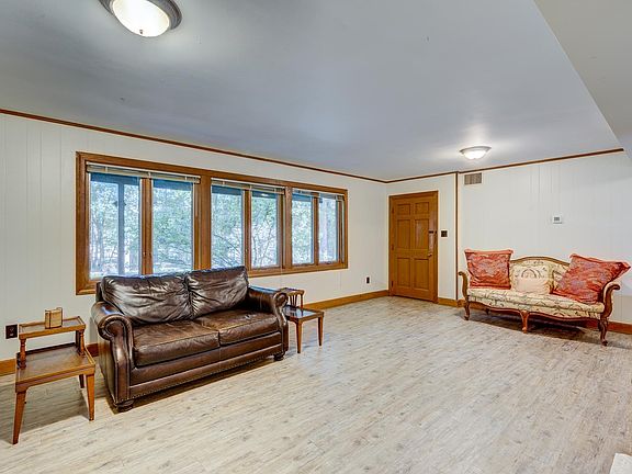 LR/DR with 6 windows facing east. Leather couch for use by tenant. Only leather couch included.