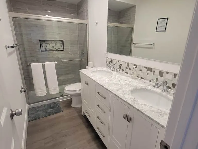 Impeccable modern bathroom with toilet, shower, sink, and essential amenities.