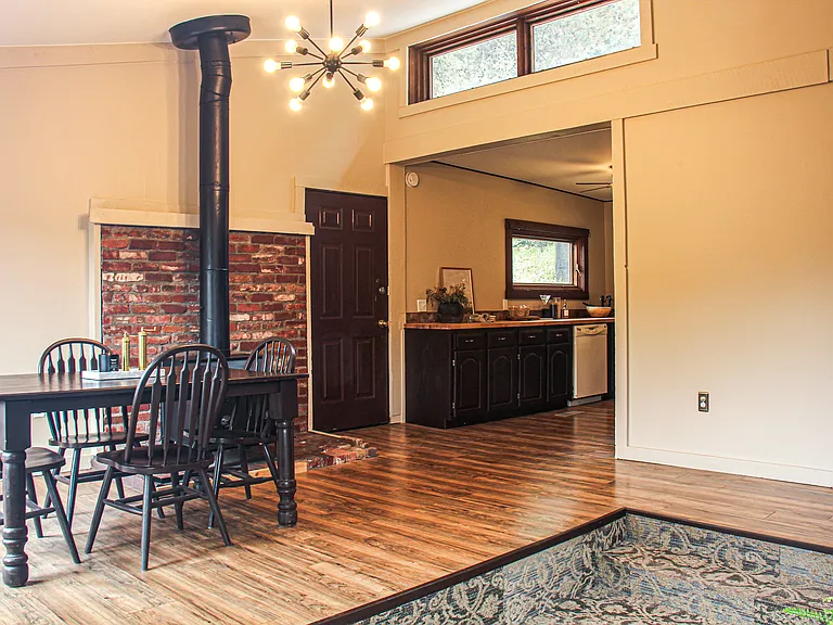 Dining area with skylights and kitchen off the sunken living room.