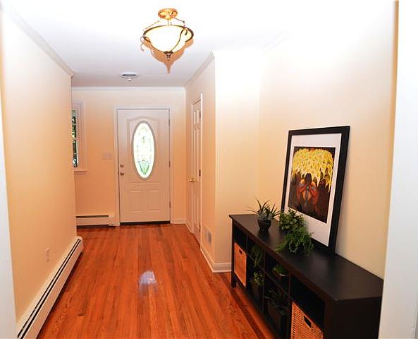 Spacious foyer with refinished hardwood floors