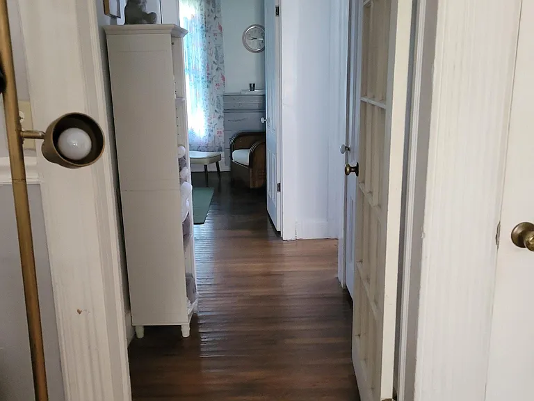 Bedroom and Bath hallway looking to living room. Hardwoods of 1890s