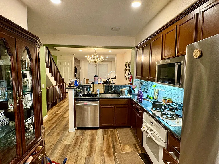 Upgraded kitchen with luxury vinyl planks and stainless appliances