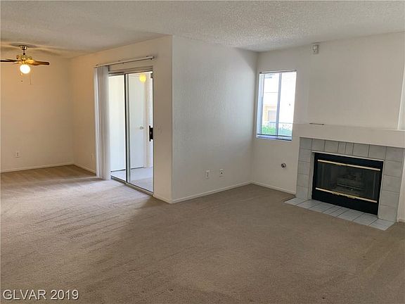 Front living room with cozy fireplace and patio access