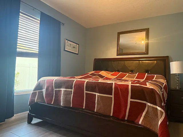Comfortable bedroom featuring natural light and modern finishes.