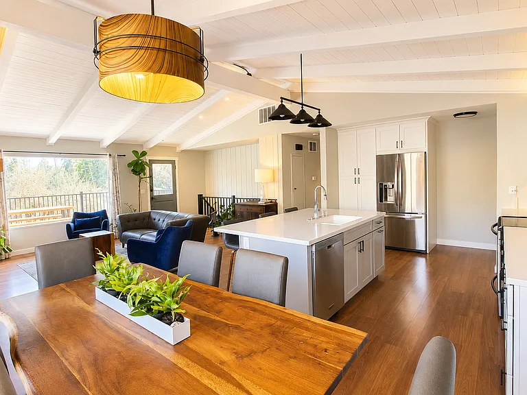 Dining and Kitchen - Open Concept - Feature Lighting over the Kitchen Island and Dining Table - Vaulted Ceilings - Exposed Beams