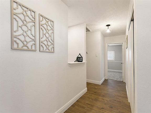 Hallway to the right when you walk in. Great size linen closet/ coat closet with custom shelving.