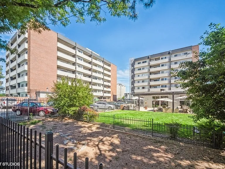 Community green space framed by mid-rise buildings