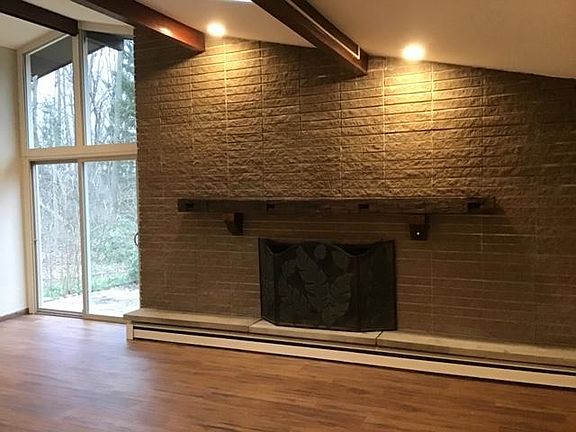 Wood burning fireplace in the great room with slidding door to patio and 2 sky lights