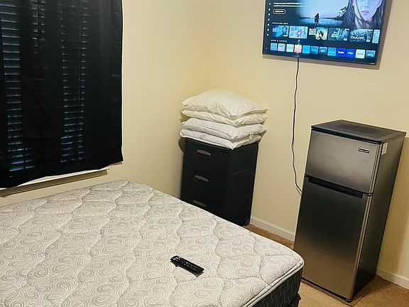 YOUR BEDROOM, although a table and chair has been added in the corner beneath the TV