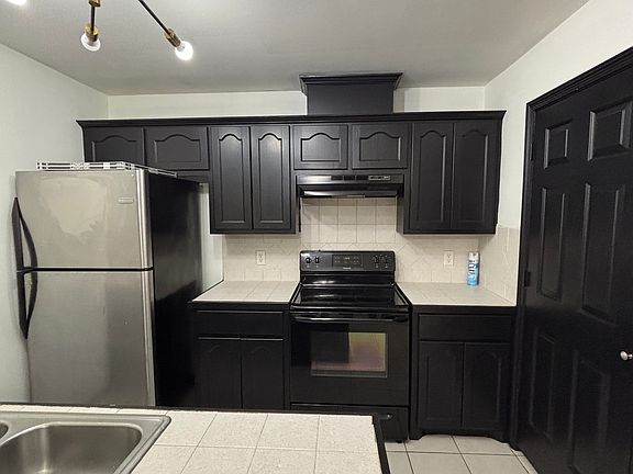 kitchen with stove and fridge