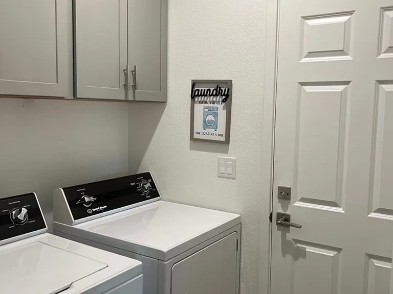 Indoor laundry room with washer and dryer included