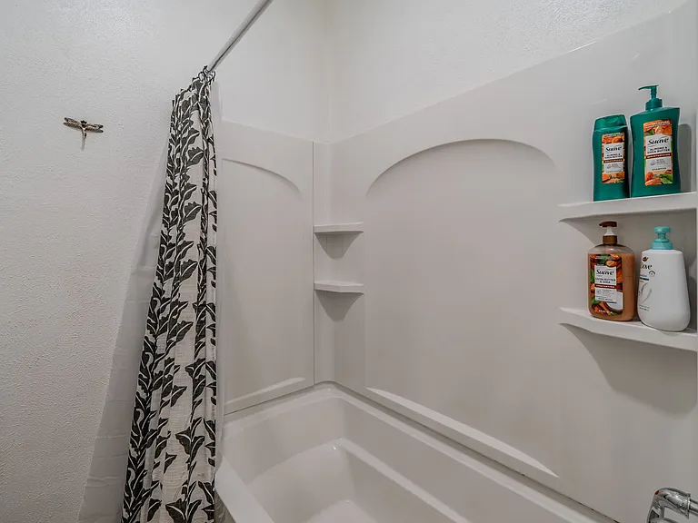 Refresh in the clean, white bathtub and shower combo.