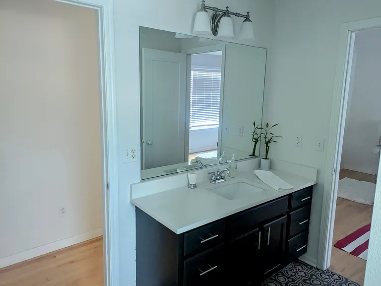 2nd bathroom - two doors, window and tiled shower/ tub surround