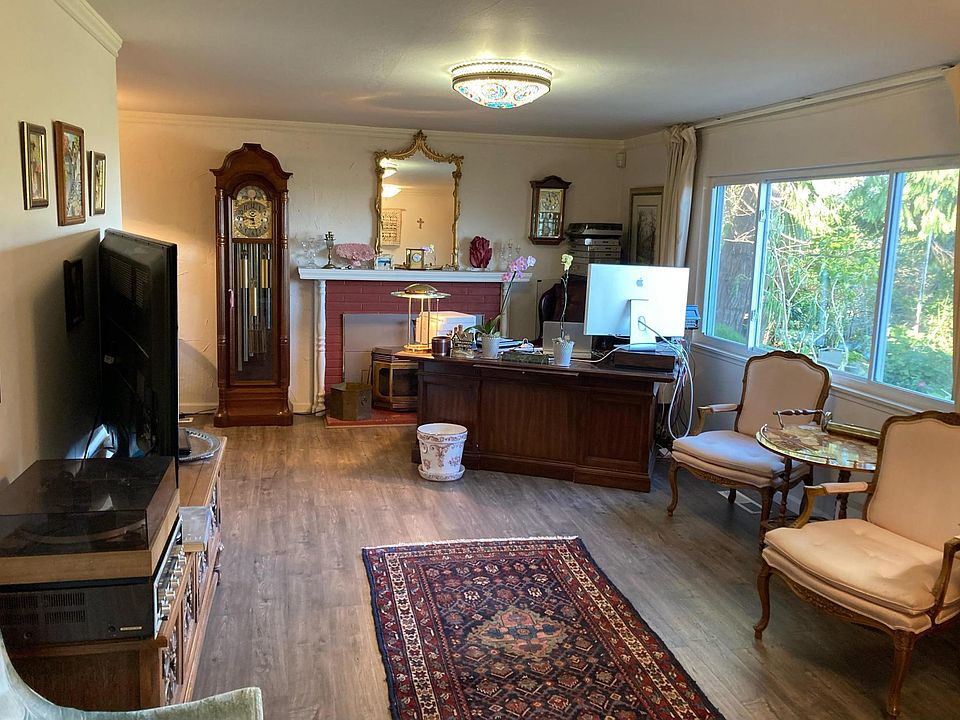 Living Room. From here enjoy sunsets out the front window through filtered trees. Views of Sonoma & Napa Mtns. An unusual place in the East Bay Hills.