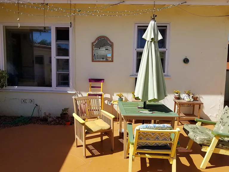 Backyard patio with large master bedroom window