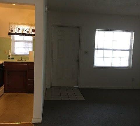Front entrance to living room Shows part of kitchen and Dining area