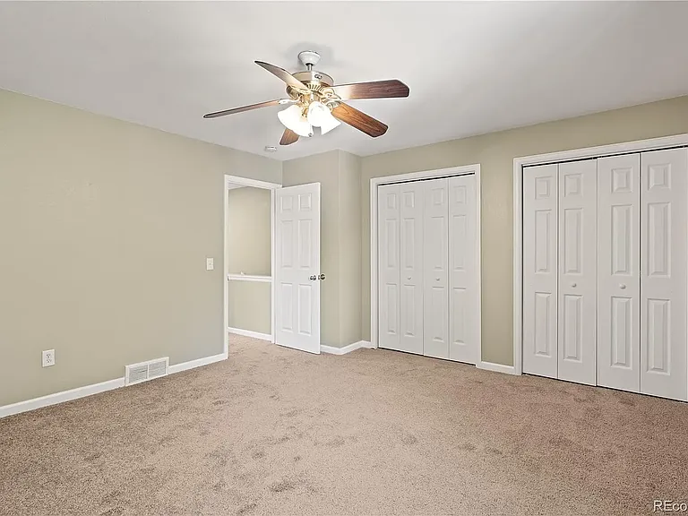 Upstairs master bedroom with dual closet doors. (upgraded ceiling fan and paint not pictured)