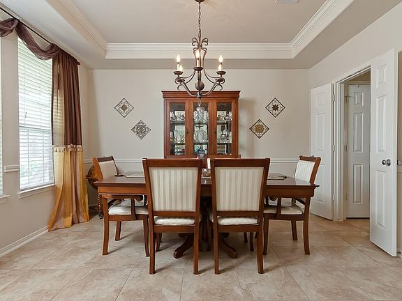 To the left of the foyer lies the dining room with tray ceilings with crown and chair rail moldings.