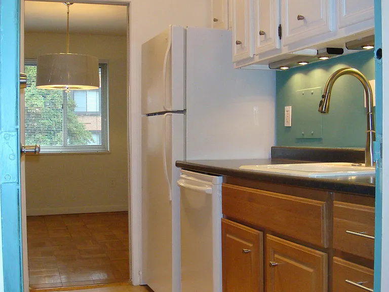 Kitchen features gas range, dishwasher, refrigerator.