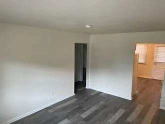 Living room view to kitchen and door to bedrooms