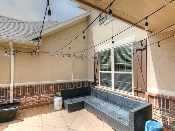 This courtyard entry is a great way to greet guests! Upgrades include brick walkway to the front doors and the stained concrete.