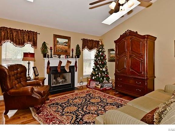 Spacious family room with newer hardwood floors and vaulted ceiling.