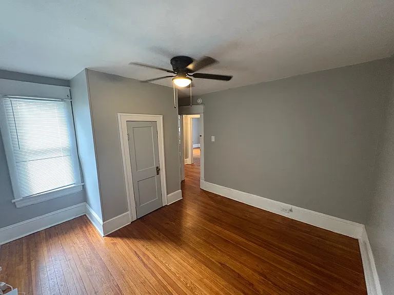 Second Bedroom w/ Designer Ceiling Fan and Newly Refinished Hardwood Floors. Newly Installed Closet Door to be Painted White.