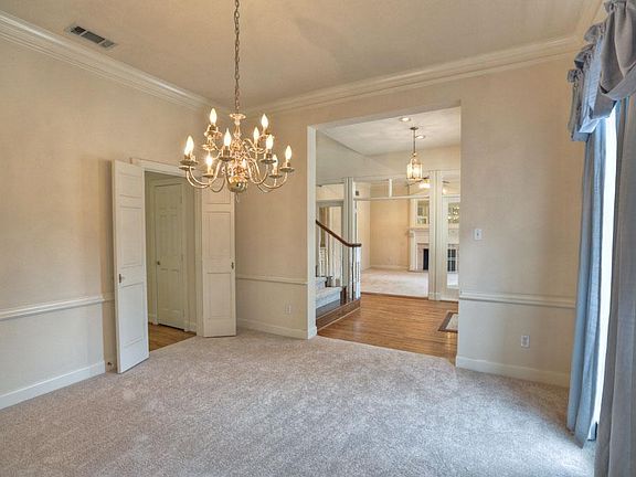 Large formal dining room has plenty of room for full dining set.