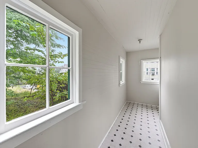 Back stairway with Access to Basement and Shared Laundry on Site