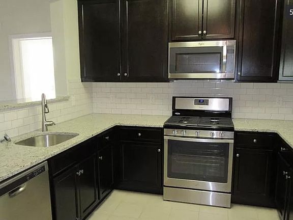 Kitchen with appliances. Oven, microwave, refrigerator, and dishwasher.