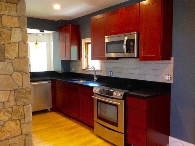 All stainless appliances Dishwasher, electric glass cooktop stove, microwave, fridge); wood cabinets and granite counters