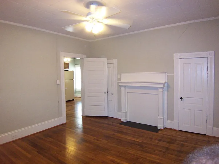 Bedroom w/ two closets, hardwood floors, ceiling fan