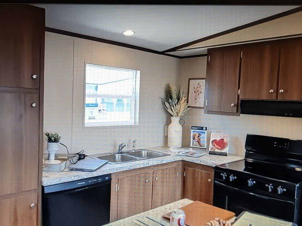 Kitchen, dishwasher pantry with window at sink.