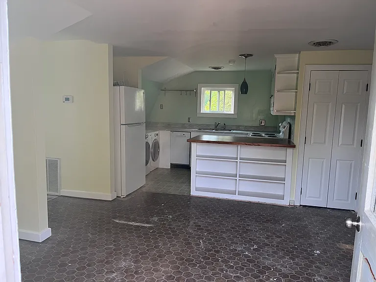 View from front door. Bedroom to the left; bathroom to the right. New carpet coming soon.