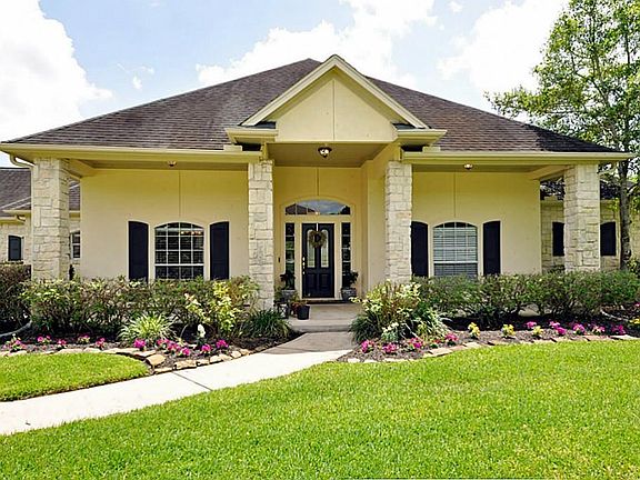 THE FRONT PORCH ENTRY IS VERY INVITING! WONDERFUL LANDSCAPING THOUGHOUT!