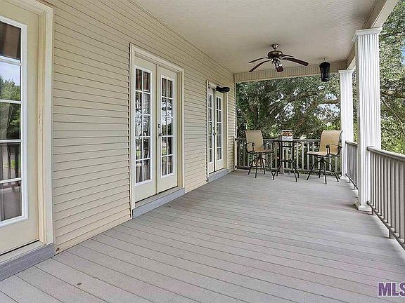 Entertain your friends on the expansive 2nd floor patio with view of pool and grounds and framed by flowering myrtles.