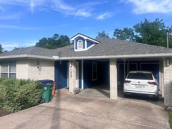 Front view -- 2 carport covered parking + off street parking for 2+ additional cars.