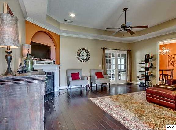 Hardwood floor and fireplace are great features in large living room!