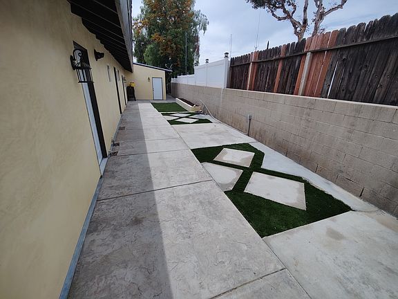 Laundry room exterior entrance with direct access from the side walkway.
